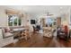 Open-concept living room with a fireplace, built-in seating, and large windows offering ample natural light at 3930 Red Rock Way, Sarasota, FL 34231
