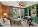 Inviting home office with custom built-ins, a ceiling fan, and French doors leading to the outdoors at 3930 Red Rock Way, Sarasota, FL 34231