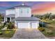 Beautiful two-story home with a two-car garage and a brick driveway near lush landscaping and waterfront at 5204 Title Row Dr, Bradenton, FL 34210