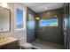 Modern bathroom featuring elegant tile work, a glass shower, and gold fixtures at 630 Companion Way, Longboat Key, FL 34228