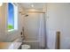 Bright bathroom featuring modern fixtures, stylish textured walls, and a shower-tub combination with brass hardware at 630 Companion Way, Longboat Key, FL 34228