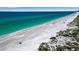 Breathtaking aerial view of the stunning white sand beach and clear blue ocean water at 630 Companion Way, Longboat Key, FL 34228