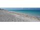 Wide sandy beach with clear turquoise water at 630 Companion Way, Longboat Key, FL 34228