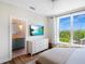 Bright bedroom with large window, hardwood floors, and en-suite bathroom at 630 Companion Way, Longboat Key, FL 34228