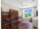 bedroom with bunkbeds offers functional design with a window view and cheerful decor at 630 Companion Way, Longboat Key, FL 34228