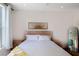 A bright bedroom features a statement headboard with clean white bedding and light walls at 630 Companion Way, Longboat Key, FL 34228