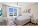 Bright bedroom featuring large window, neat bed with stylish bedding, and matching nightstands at 630 Companion Way, Longboat Key, FL 34228