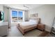 Bright bedroom with a large window and a ceiling fan features warm wood furnishings and a stylish area rug at 630 Companion Way, Longboat Key, FL 34228