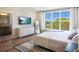 Bedroom features a large window and a white comforter with a blue blanket accent at 630 Companion Way, Longboat Key, FL 34228