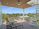 Outdoor deck with lounge chairs, spiral staircase, and neighborhood views at 630 Companion Way, Longboat Key, FL 34228