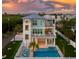 Beautiful three-story coastal home featuring private pool, rooftop terrace, and architectural details at 630 Companion Way, Longboat Key, FL 34228