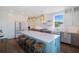 Contemporary kitchen featuring a large island with seating, stainless appliances, and stylish pendant lighting at 630 Companion Way, Longboat Key, FL 34228