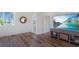 Bright, airy living room with hardwood floors, a TV, and a view of the outside at 630 Companion Way, Longboat Key, FL 34228