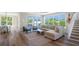 Comfortable living area with cozy seating, hardwood floors, and access to the outdoor patio at 630 Companion Way, Longboat Key, FL 34228
