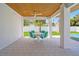 Enjoy outdoor dining with this covered patio featuring a modern table, seating, and elegant architectural elements at 630 Companion Way, Longboat Key, FL 34228