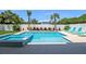 A relaxing backyard pool and spa with lounge chairs and surrounding tropical landscaping at 630 Companion Way, Longboat Key, FL 34228