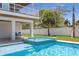Inviting pool and jacuzzi, surrounded by a manicured lawn and a charming outdoor dining area at 630 Companion Way, Longboat Key, FL 34228