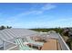 The rooftop deck is complete with lounge chairs and a table, perfect for enjoying stunning panoramic views at 630 Companion Way, Longboat Key, FL 34228