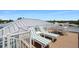 This rooftop deck features lounge chairs and a table, ideal for soaking up the sun and enjoying the beautiful surroundings at 630 Companion Way, Longboat Key, FL 34228