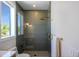 Contemporary bathroom shower with glass door, sleek fixtures, and textured wall tiles at 630 Companion Way, Longboat Key, FL 34228