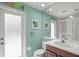 Bathroom featuring decorative door, sink with vanity, and decorative mirror at 790 Shadow Bay Way, Osprey, FL 34229