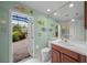 Well-decorated bathroom features unique fish decor and access to a screened lanai at 790 Shadow Bay Way, Osprey, FL 34229