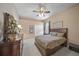 Bedroom with ceiling fan, closet, window, and decorative accents at 790 Shadow Bay Way, Osprey, FL 34229