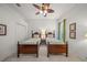 Cozy bedroom featuring twin beds, ceiling fan, and serene decor for a relaxing space at 790 Shadow Bay Way, Osprey, FL 34229