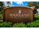 The Woodlands at Rivendell community sign is brick with decorative landscaping at 790 Shadow Bay Way, Osprey, FL 34229