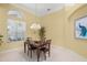Dining area featuring chandelier and an arched window with natural light at 790 Shadow Bay Way, Osprey, FL 34229