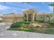 Charming home showcasing lush landscaping, a three-car garage, and inviting front entryway at 790 Shadow Bay Way, Osprey, FL 34229