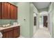 Hallway with built in storage, mirrored closet, and natural light at 790 Shadow Bay Way, Osprey, FL 34229