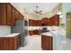 Well-equipped kitchen with stainless steel appliances, wooden cabinets, and plenty of countertop space at 790 Shadow Bay Way, Osprey, FL 34229