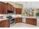 Modern kitchen featuring stainless steel appliances, white countertops, and rich wood cabinetry at 790 Shadow Bay Way, Osprey, FL 34229
