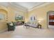 Bright living room with plush carpet, neutral colors, and sliding doors to screened patio at 790 Shadow Bay Way, Osprey, FL 34229