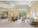 Bright living room features an elegant sitting area and sliding door access to outdoor patio at 790 Shadow Bay Way, Osprey, FL 34229