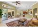 Open-concept living space with seamless transition to outdoor patio, kitchen, dining and living rooms at 790 Shadow Bay Way, Osprey, FL 34229