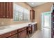 Office area with built in desk, cabinets, and natural light at 790 Shadow Bay Way, Osprey, FL 34229