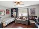 Eclectic bedroom featuring hardwood floors, a cozy loveseat, and unique wall decor for personal flair at 1655 58Th S Ter # 7, St Petersburg, FL 33712