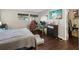 Bedroom with hardwood floors, two computer stations, a large window, and a comfortable bed at 1655 58Th S Ter # 7, St Petersburg, FL 33712
