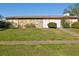The building's exterior has a well-maintained lawn and landscape, with stairs leading to the unit entrance at 1655 58Th S Ter # 7, St Petersburg, FL 33712