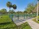 Fenced small dog park area with green fence and trees for shade in a grassy park at 1655 58Th S Ter # 7, St Petersburg, FL 33712