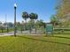 A fenced dog park with a sign and palm trees in the background at 1655 58Th S Ter # 7, St Petersburg, FL 33712