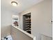 A hallway with wall shelving and a nook with bowling equipment, leading to another room at 1655 58Th S Ter # 7, St Petersburg, FL 33712