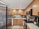 Well-lit kitchen featuring wood cabinets, stainless steel appliances, and a tile backsplash at 1655 58Th S Ter # 7, St Petersburg, FL 33712