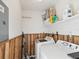 Functional laundry room with a modern washer and dryer, storage shelves, and practical wood paneling at 1655 58Th S Ter # 7, St Petersburg, FL 33712