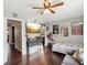 Cozy living room with hardwood floors, a ceiling fan, a TV, and quirky decorative posters at 1655 58Th S Ter # 7, St Petersburg, FL 33712