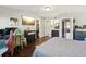 This main bedroom features hardwood floors, a gaming setup, walk-in closet, and ensuite bathroom at 1655 58Th S Ter # 7, St Petersburg, FL 33712