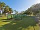 Community playground with multiple activity structures and playground equipment surrounded by trees at 1655 58Th S Ter # 7, St Petersburg, FL 33712