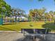 Community playground with multiple activity structures, swings, and playground equipment on a grassy area at 1655 58Th S Ter # 7, St Petersburg, FL 33712
